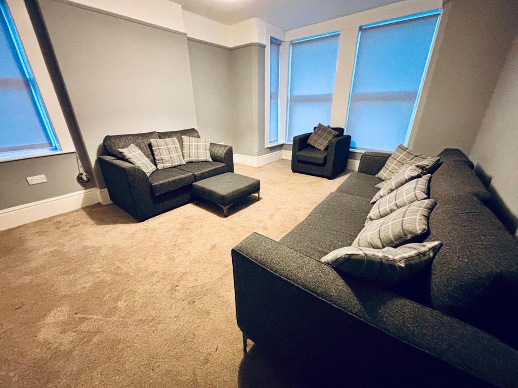 Spacious lounge with matching sofas and armchai...