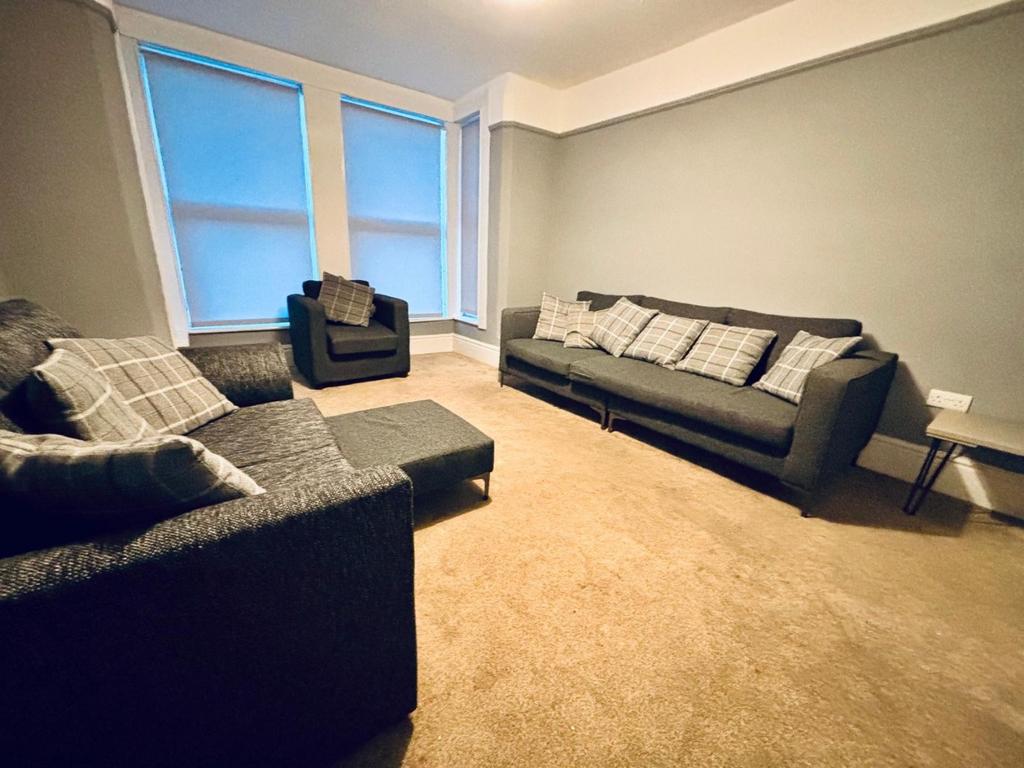 Spacious lounge with comfy sofas and bay window...