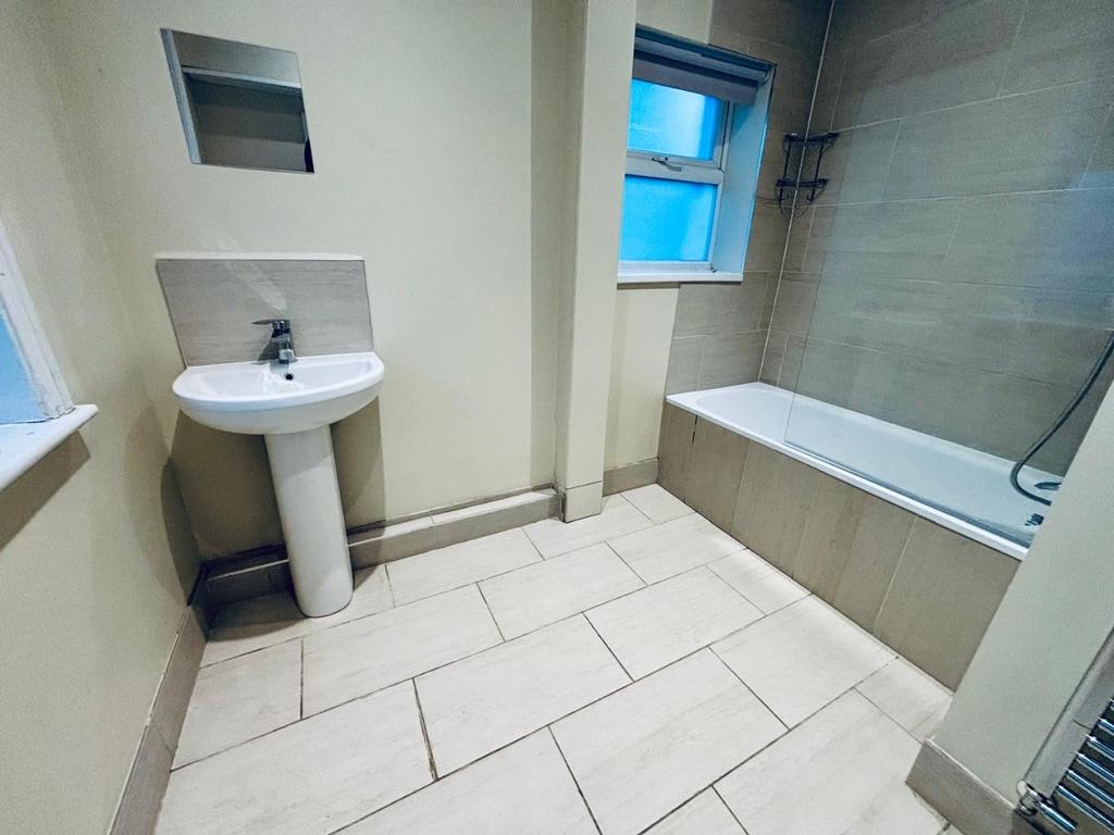 Bright modern bathroom with bath and clean tile...
