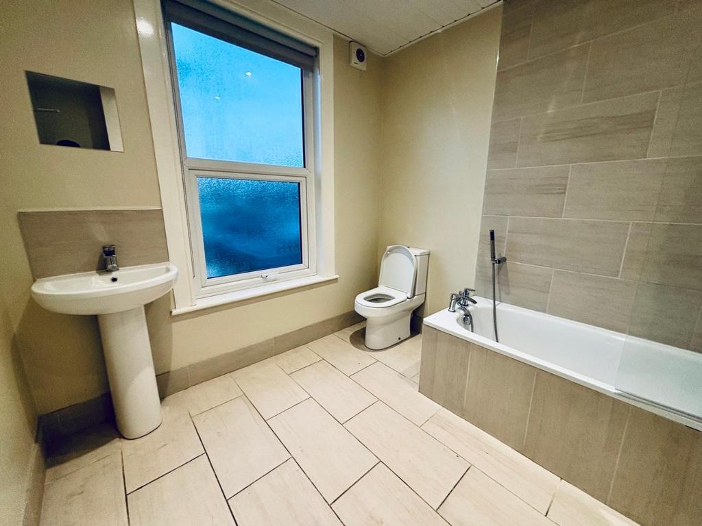 Bright, modern bathroom with bath and sink...