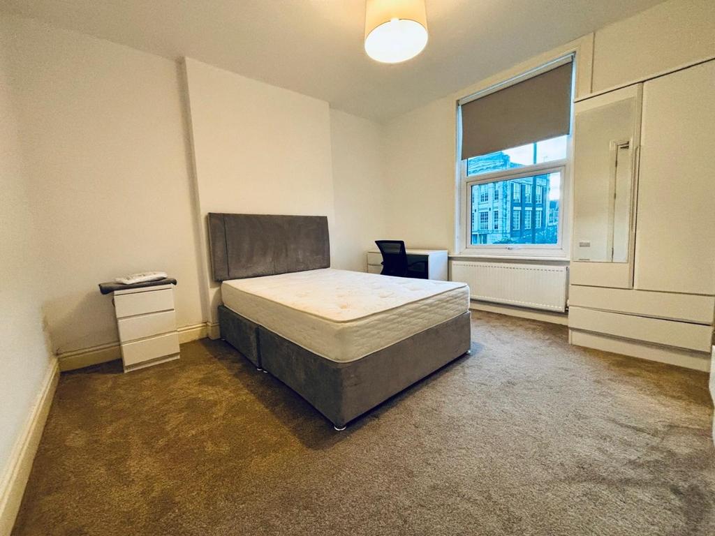 Bright double bedroom with fitted storage...
