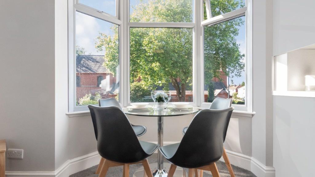 Bright bay-window seating area with street view...
