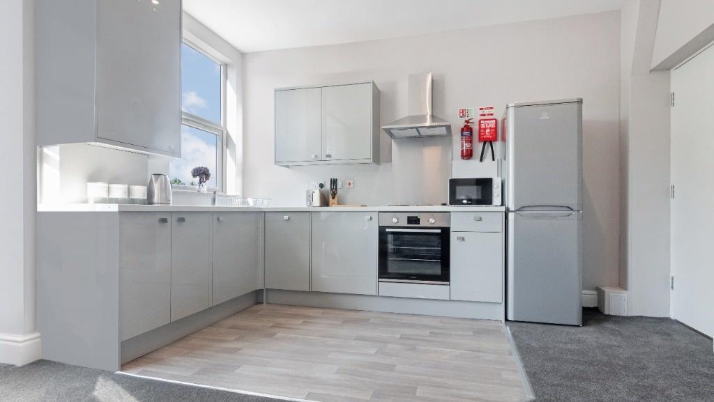 Bright modern kitchen with L-shaped units...