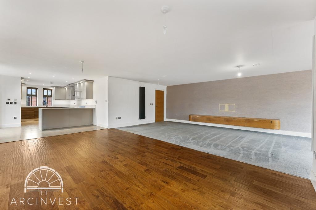 Spacious open-plan living area with modern fini...