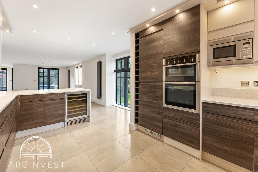 Modern open-plan kitchen with island and natura...