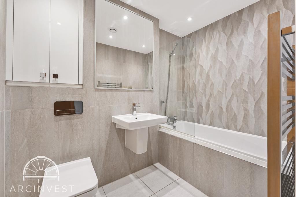 Modern bathroom with bathtub and bright tiles...