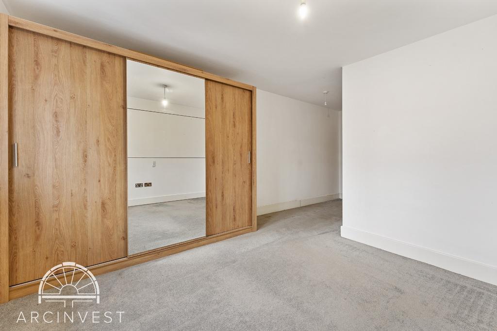 Bright bedroom with large mirrored wardrobes...