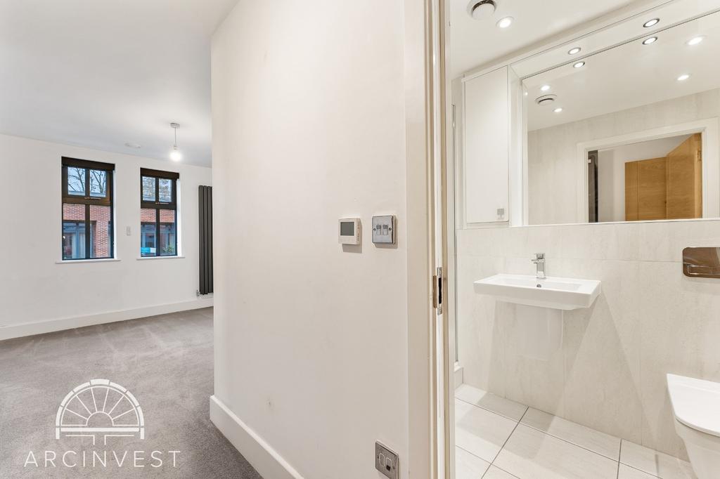 Bright hallway with modern bathroom access...