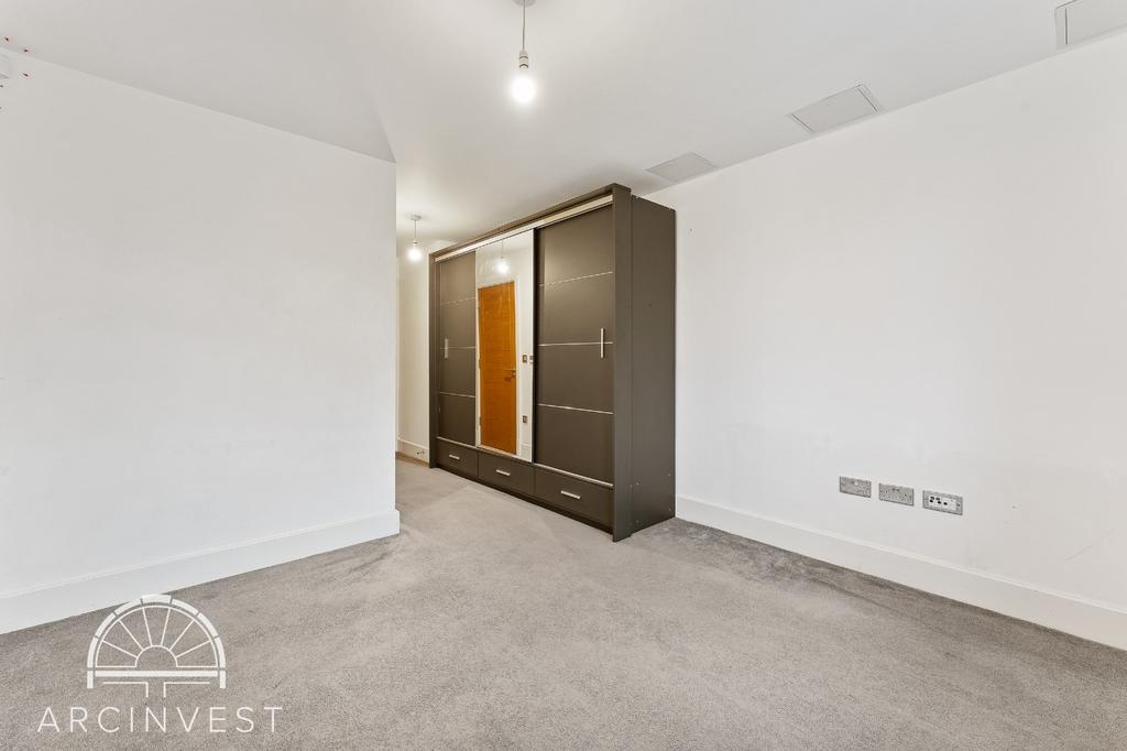 Bright bedroom with built-in wardrobe and neutr...