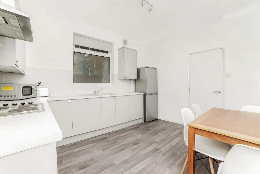 Bright modern kitchen with dining table...