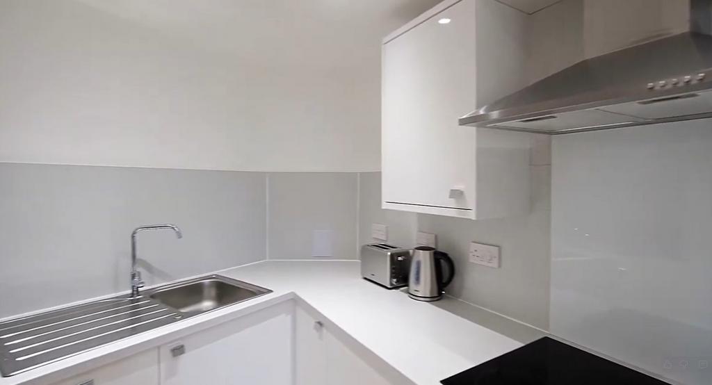 Bright modern kitchenette with sleek white unit...