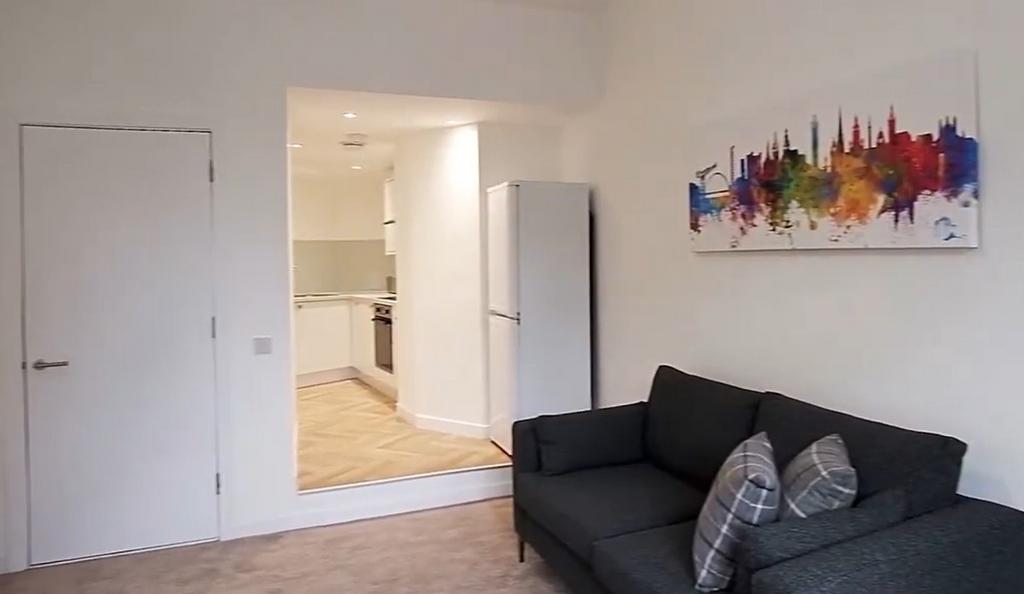 Bright lounge with comfy sofa and open kitchen...