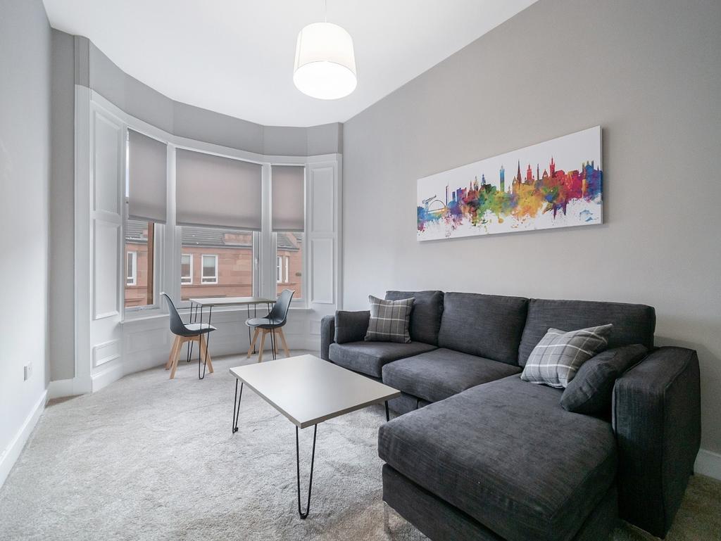 Bright living room with bay window and comfy so...