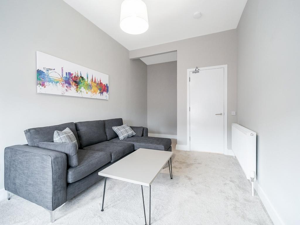 Bright modern living room with sofa and artwork...