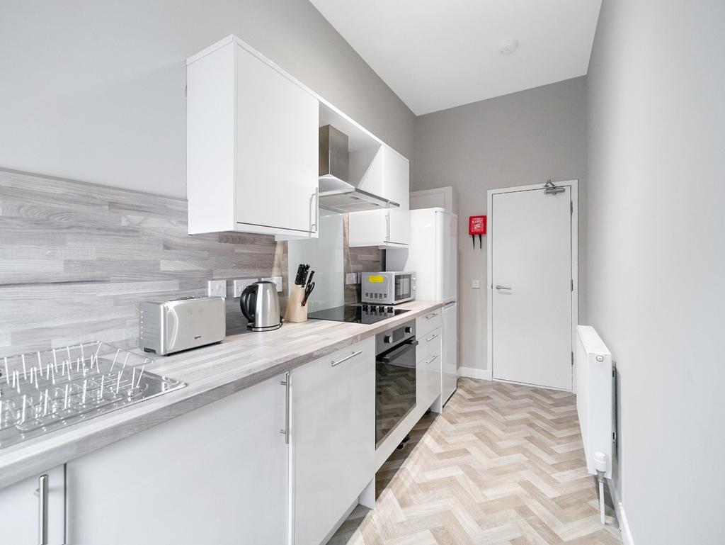 Modern fitted kitchen with integrated appliance...