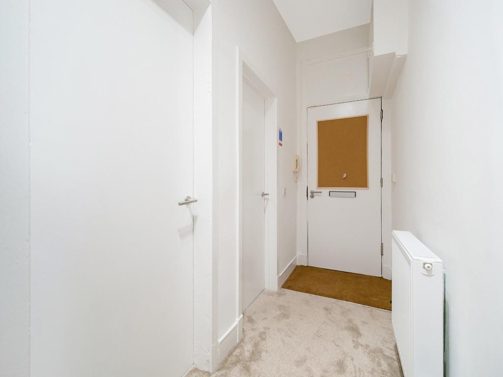 Bright, clean entrance hallway with neutral dec...