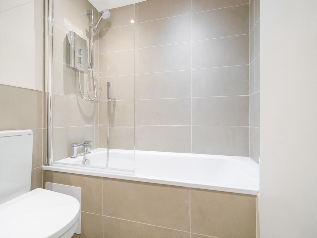 Bright modern bathroom with bathtub and shower...