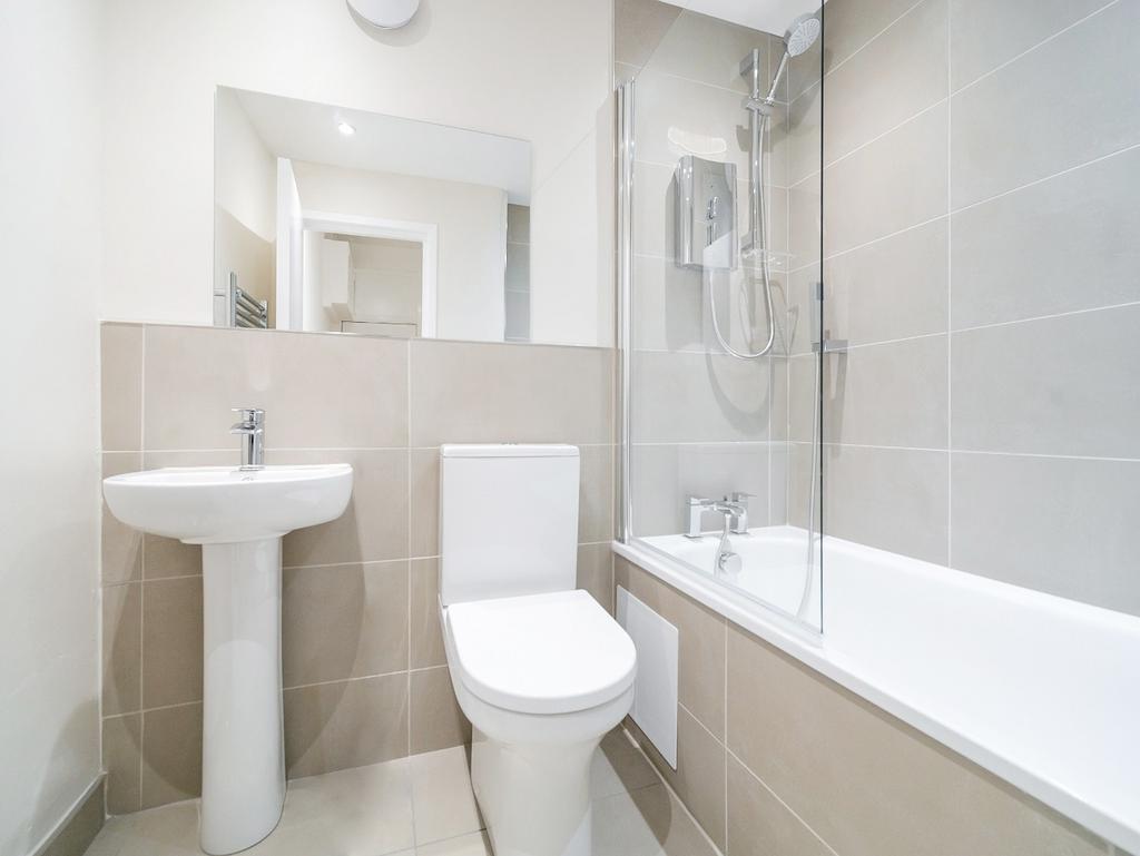 Bright modern bathroom with bath and shower...