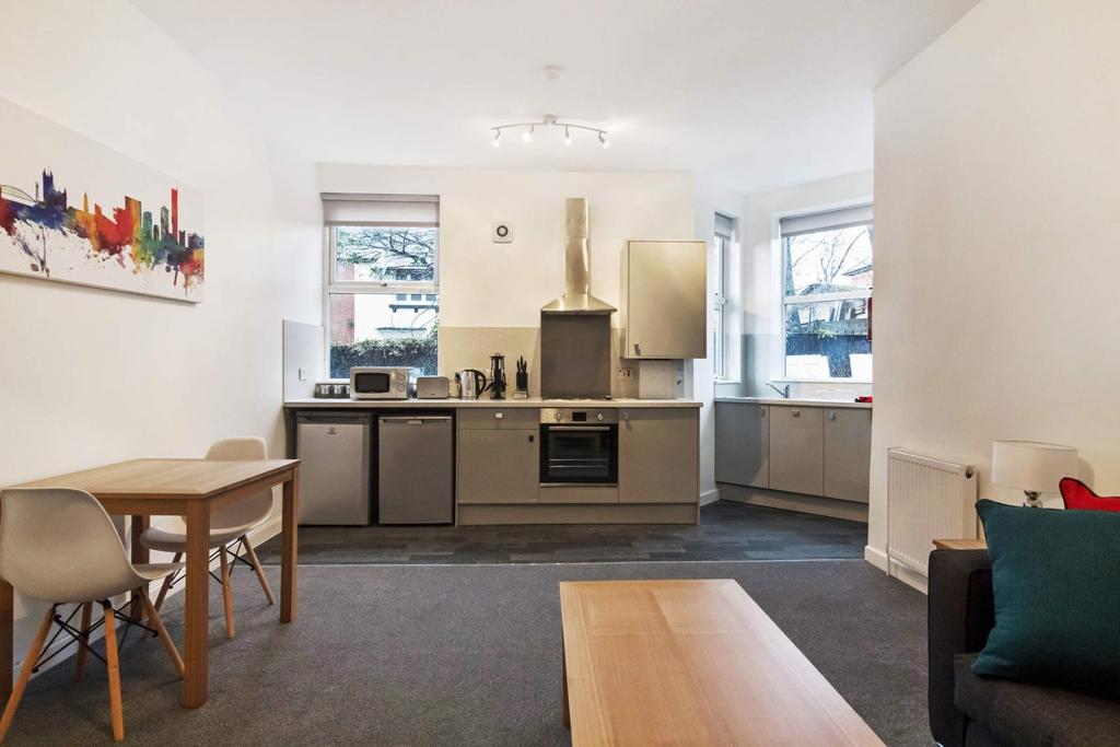 Modern open-plan kitchenette with dining spot...