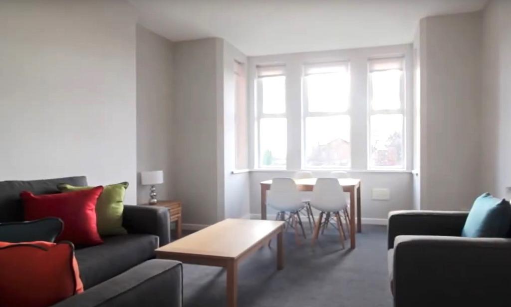 Bright, modern lounge with bay window and seati...