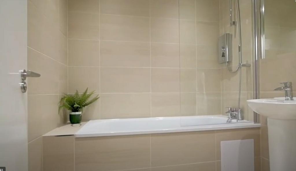 Modern tiled bathroom with bathtub and shower...