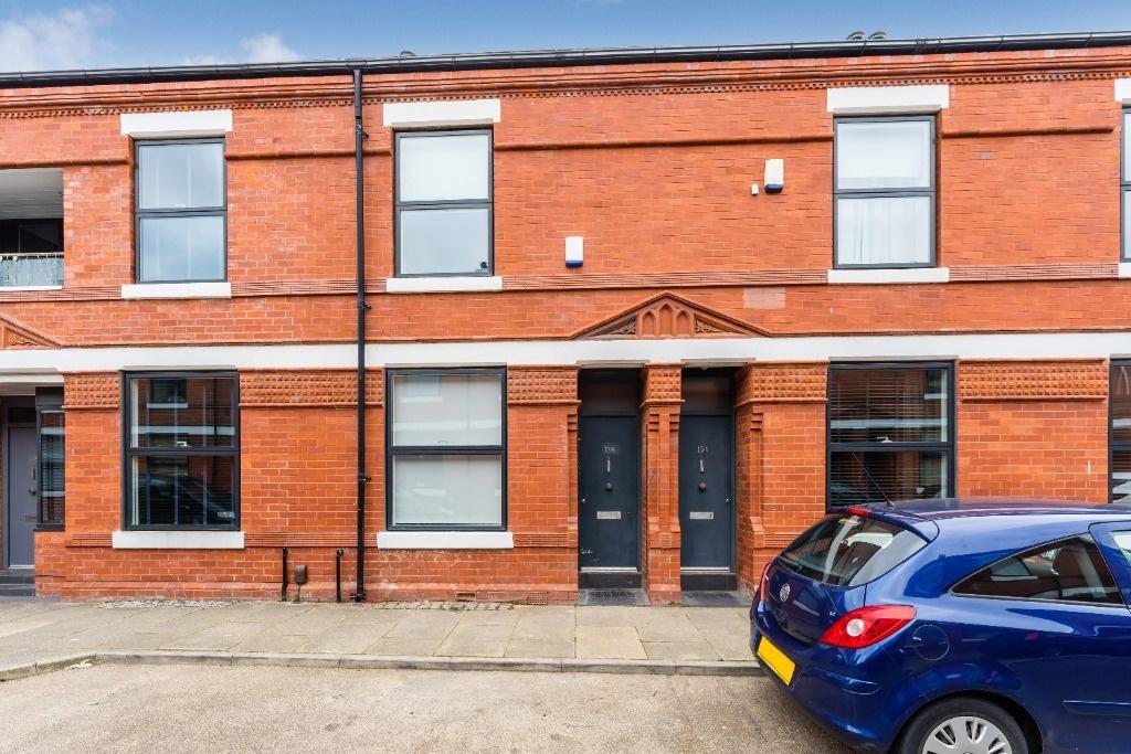 Red-brick terraced house with modern windows...