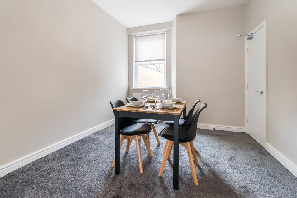 Bright dining area with modern table and chairs...
