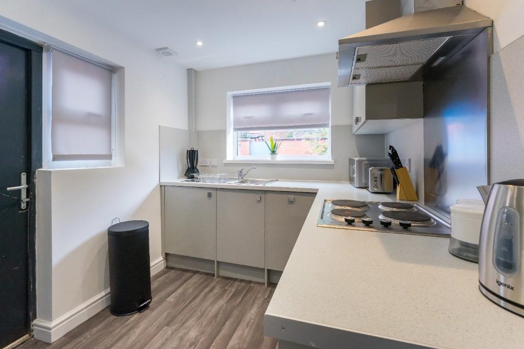 Bright modern kitchen with integrated appliance...