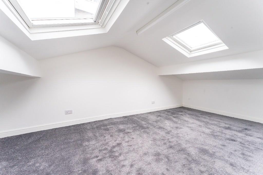 Bright loft bedroom with skylights and new carp...