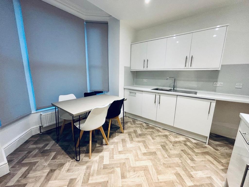 Bright modern kitchen with dinette and large ba...