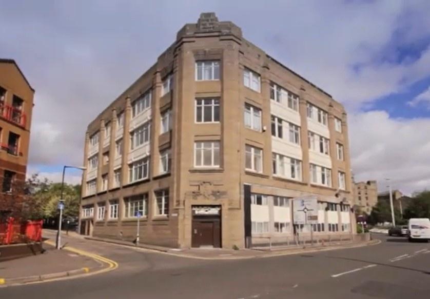 Prominent corner building with large windows...