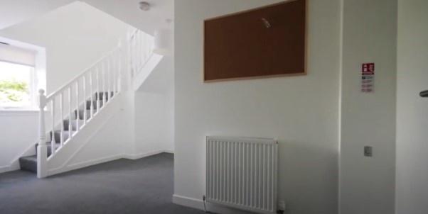 Bright entrance hallway with staircase and neut...