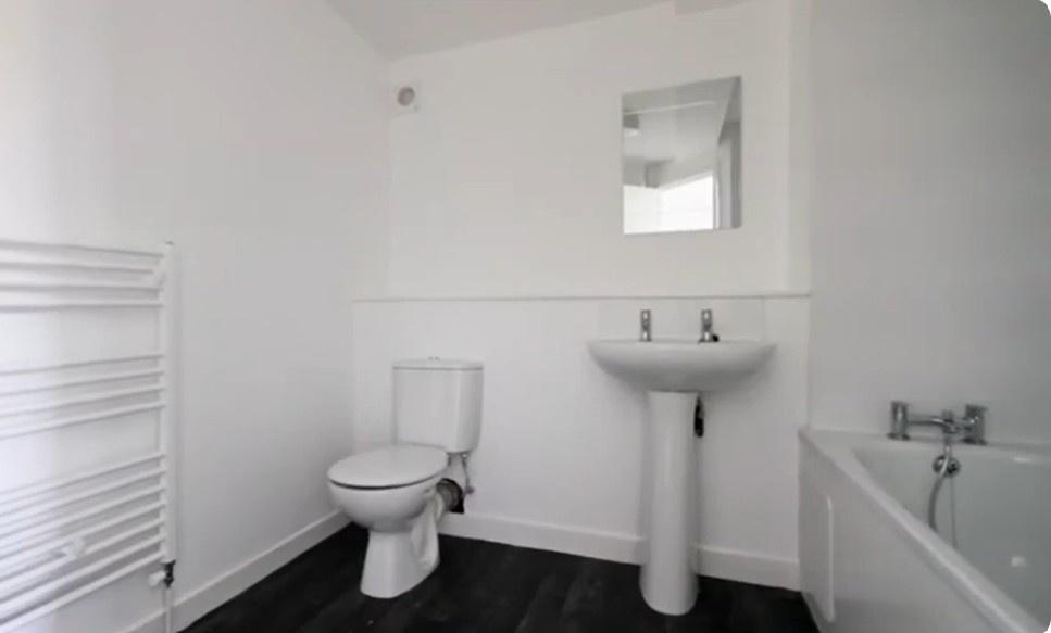 Bright modern bathroom with bath and clean fini...