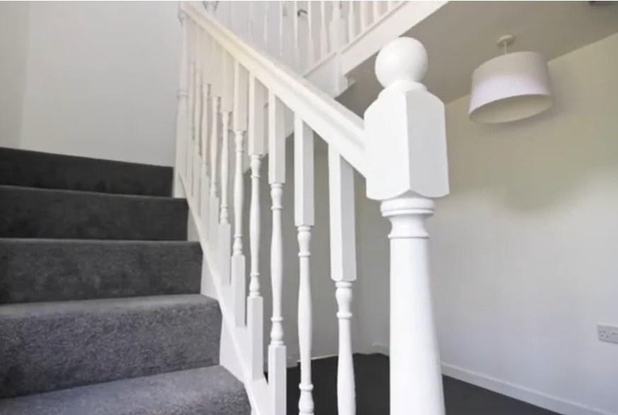 Bright, well-maintained carpeted staircase...