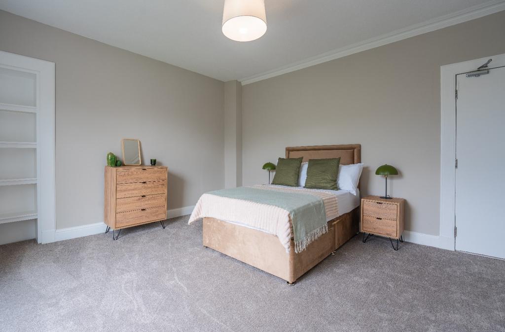 Bright, spacious bedroom with neutral decor...