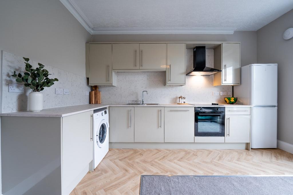 Bright modern kitchen with integrated appliance...