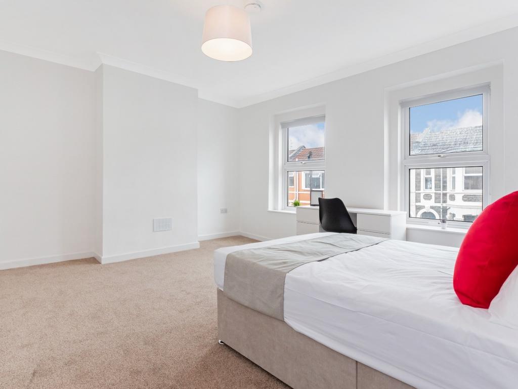 Bright bedroom with double bed and study space...