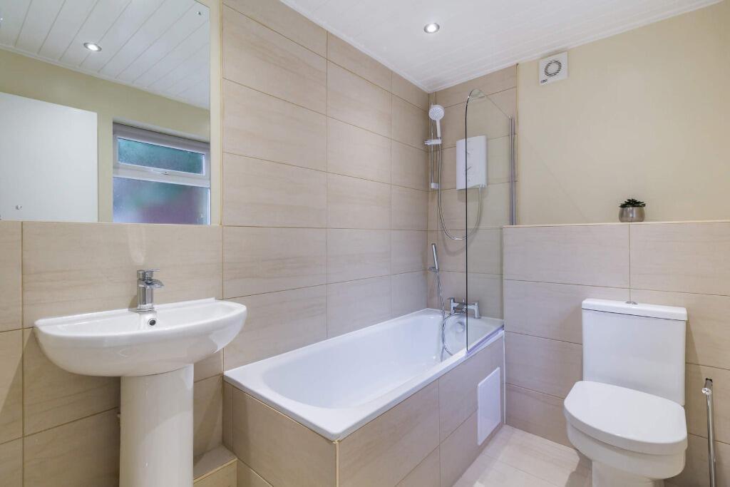 Modern bathroom with bath, shower and clean fin...