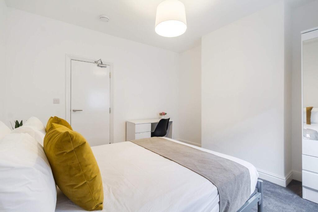 Bright, tidy bedroom with modern neutral decor...