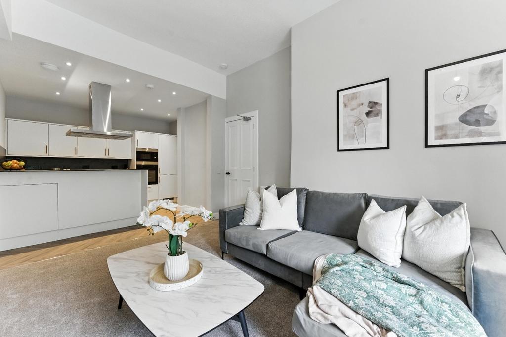 Bright, modern open-plan living area with kitch...