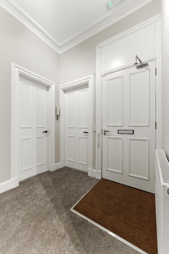 Bright, freshly painted entrance hallway with t...