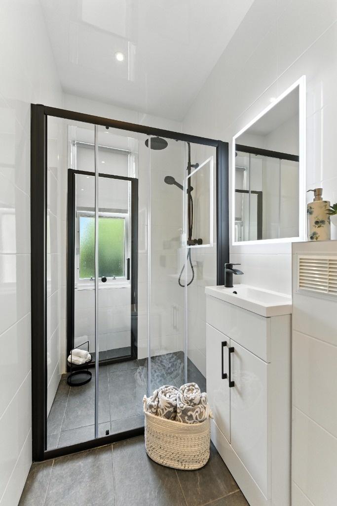 Contemporary bathroom with glass walk-in shower...
