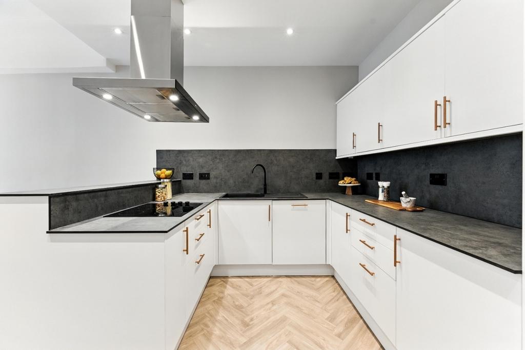 Modern white kitchen with sleek countertops...