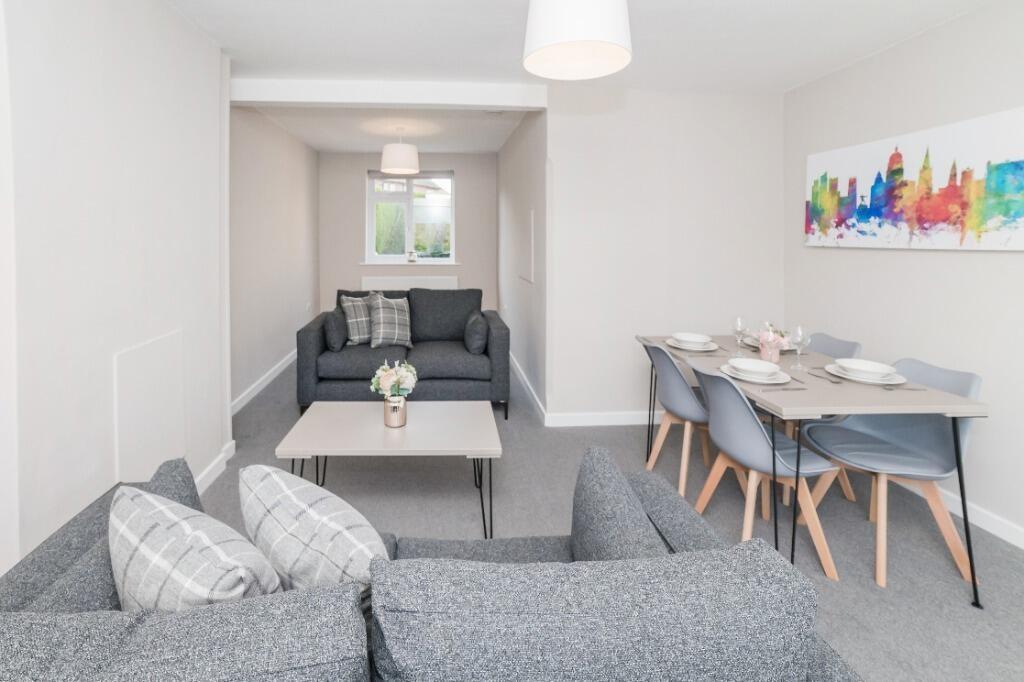 Bright modern living/dining area with sofa and ...