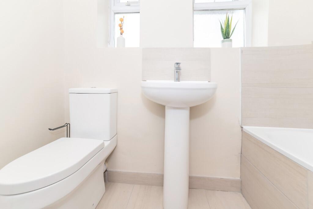 Bright modern bathroom with clean white fixture...