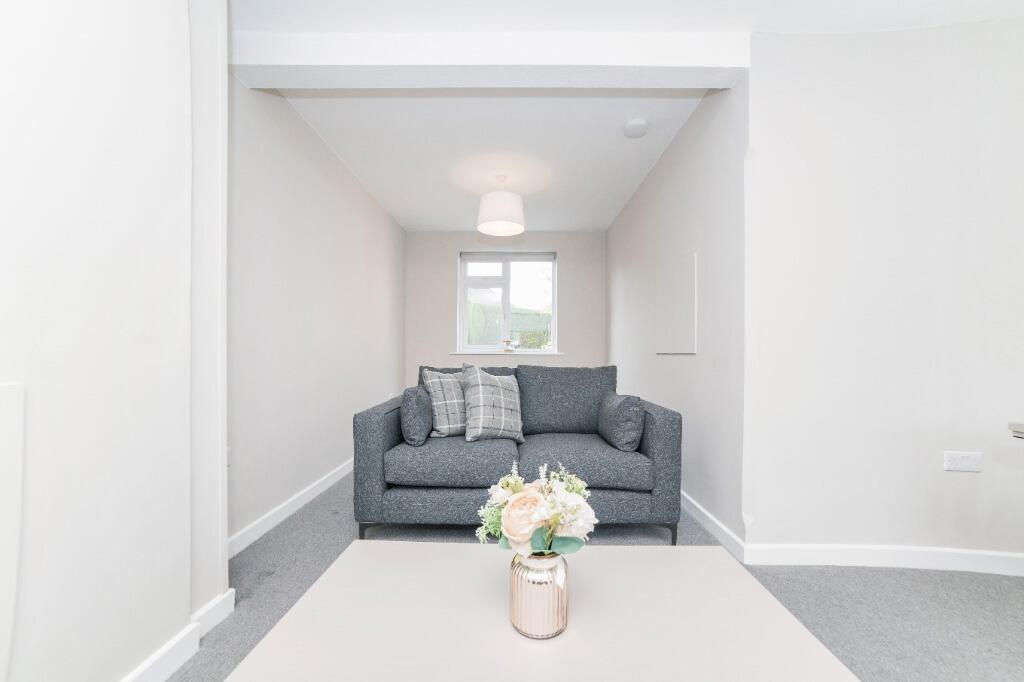 Bright, neutral lounge with cosy sofa and décor...