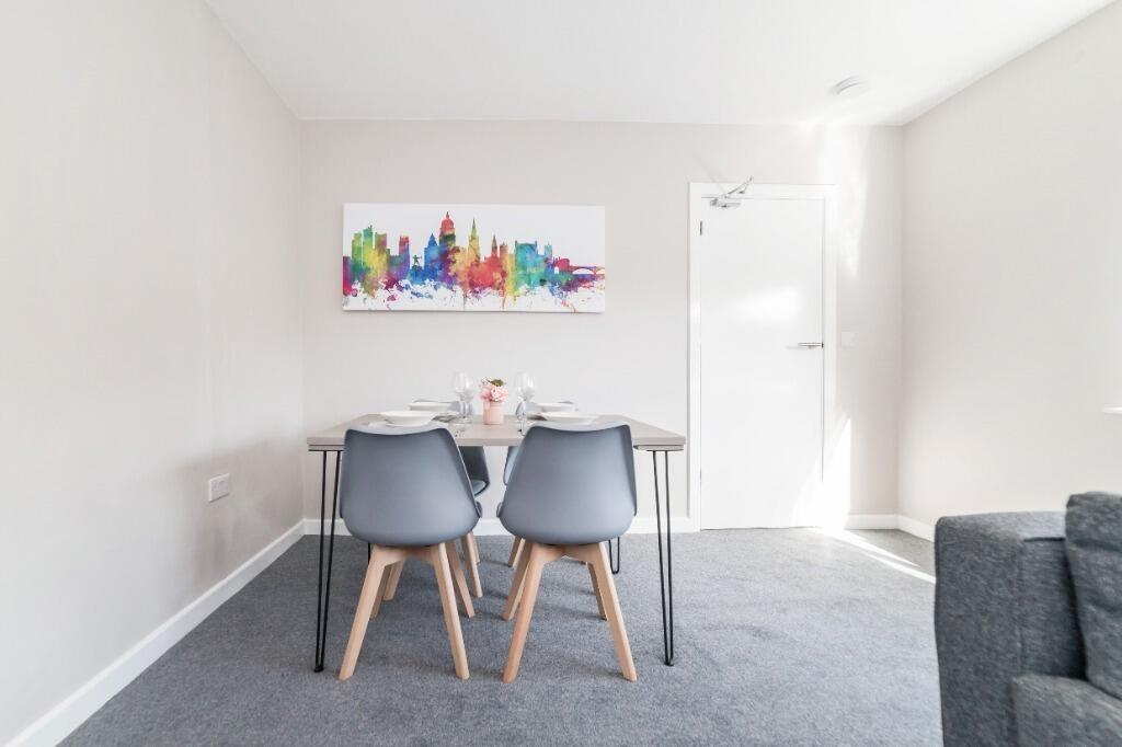 Bright dining nook with modern chairs...