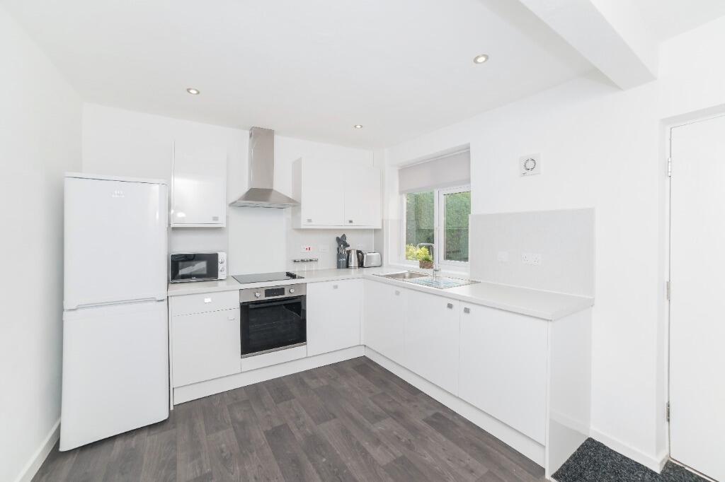 Bright modern kitchen with ample cabinets...