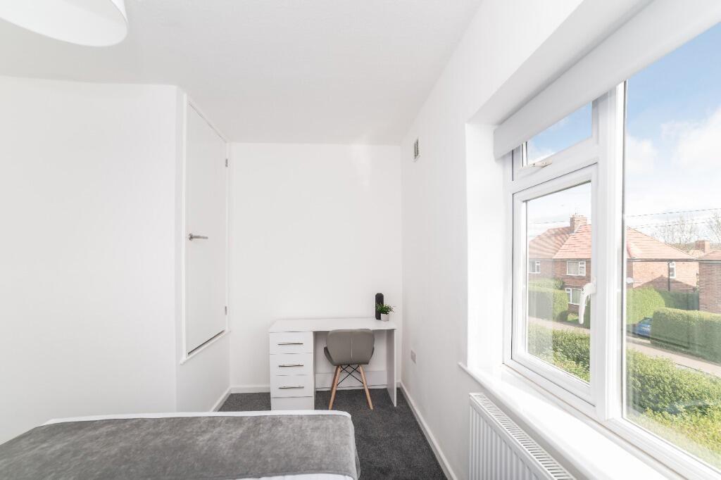 Bright bedroom with desk, bed and garden view...