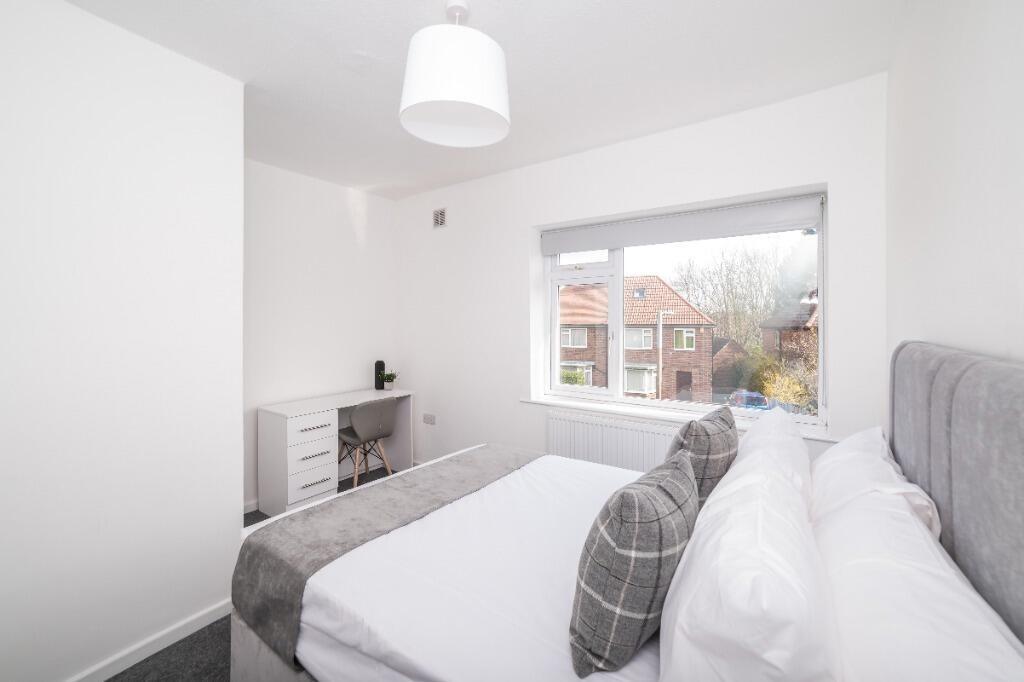 Bright, modern bedroom with large window...